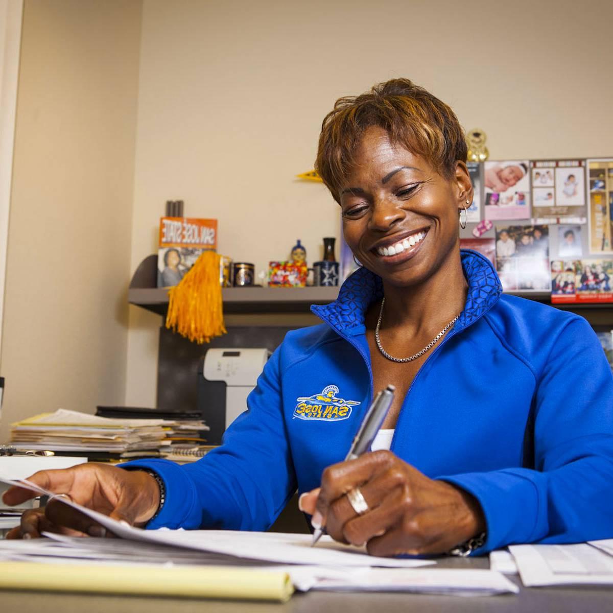 A woman signing papers